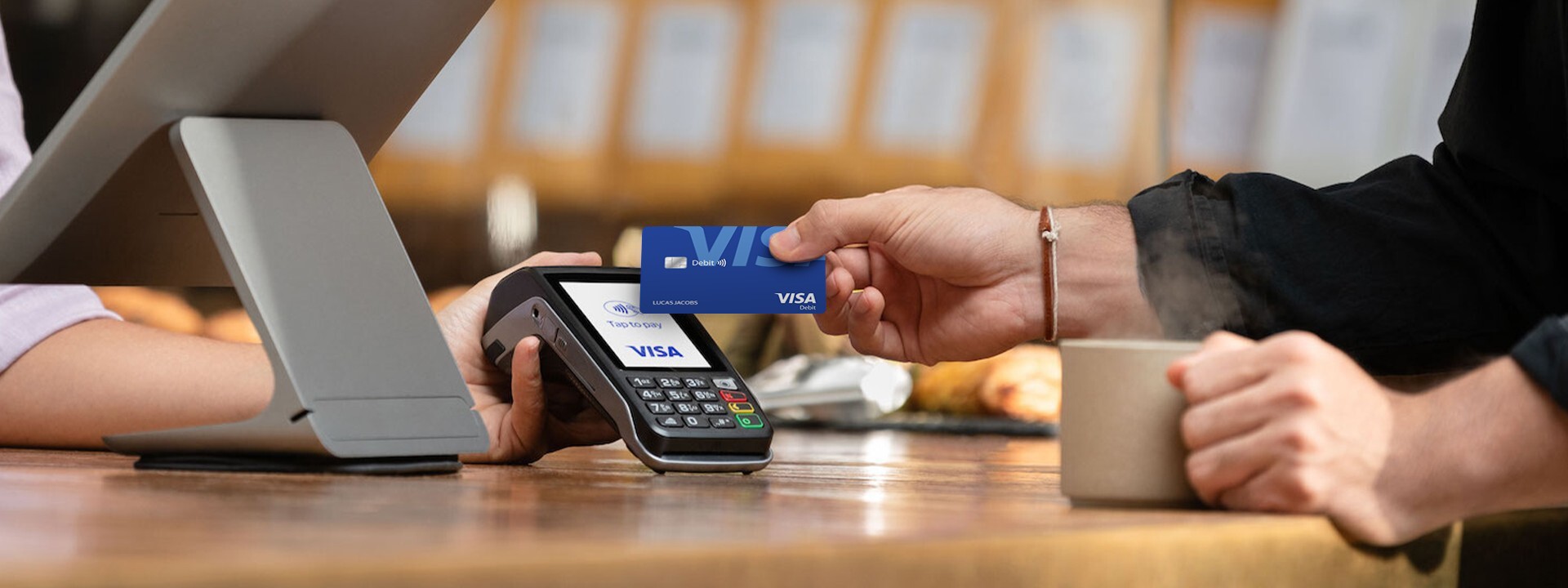 person paying with visa card contactless