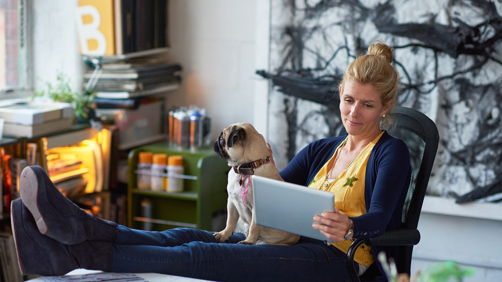 women using tablet with dog